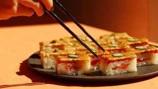 Best sushi in Toronto | Chopsticks reach for a platter of salmon oshi at Minami Toronto