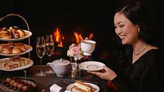 Afternoon tea and high tea in Toronto | A woman enjoying afternoon tea at EPOCH Bar & Kitchen Terrace