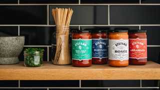 Stefano Faita pasta sauces and recipes | A lineup of Stefano Faita pasta sauces on a shelf