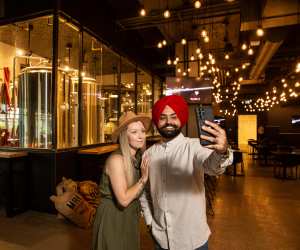 Manitoba restaurants | A couple takes a selfie at a brewery in Manitoba