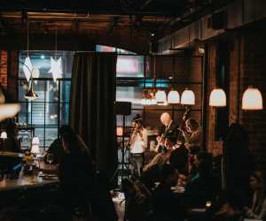 Restaurants and bars with live music in Toronto | Guests at the bar watch a small band playing inside Lapinou