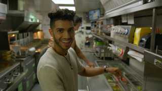 Mena Massoud | Aladdin actor Mena Massoud in a kitchen smiling