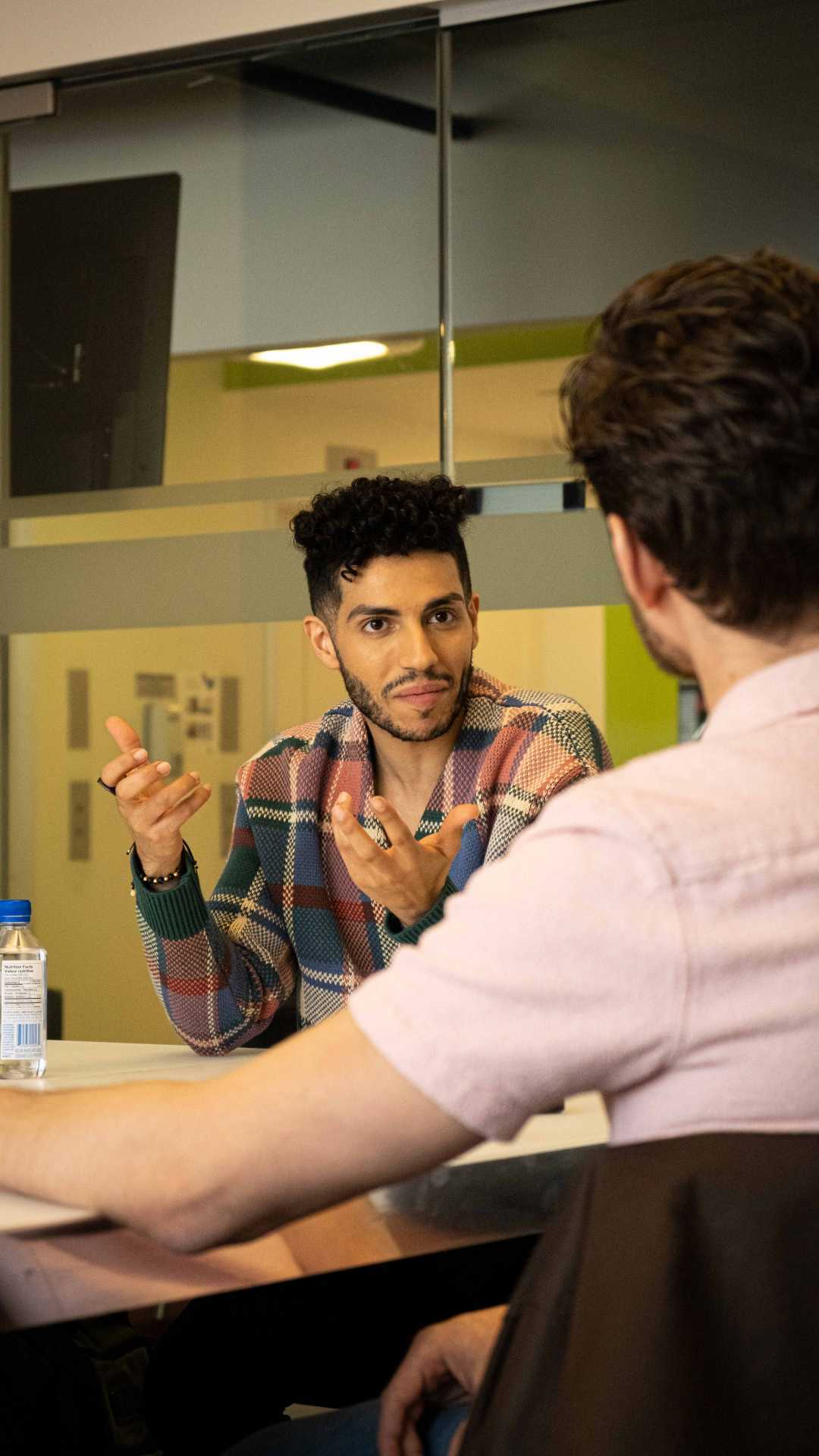 Mena Massoud | Aladdin actor Mena Massoud having a conversation at a table