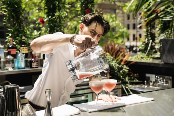 Best patios in Toronto | A bartender pouring cocktails on Chotto Matte's patio