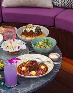 A spread of dishes on the terrace at Skylight rooftop patio at W Toronto hotel