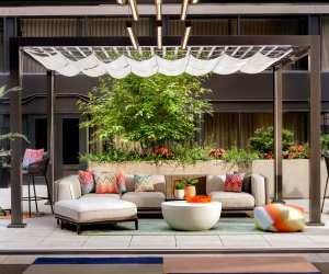 Couches and greenery on the patio, the Yard at the W Toronto hotel in Yorkville