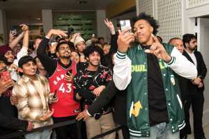 Toronto Raptor Scottie Barnes takes a photo with fans at Subway