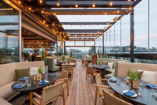 Cozy booths and tables at Harriet's Rooftop in Toronto