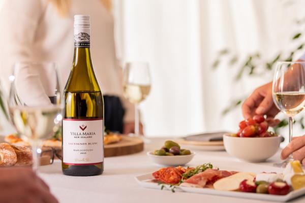 Villa Maria Private Bin Sauvignon Blanc on the dinner table with glasses and charcuterie