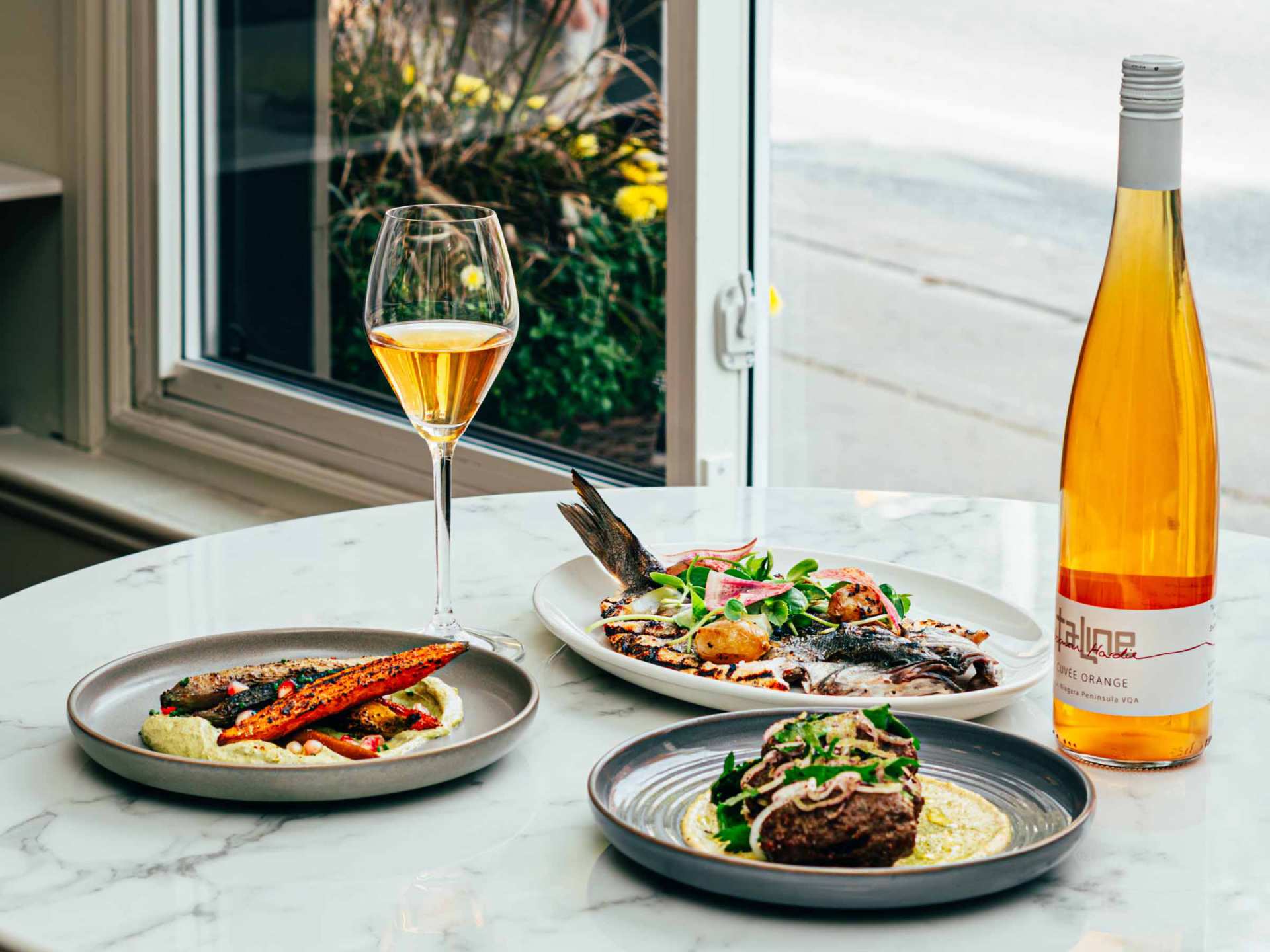 Taline Toronto | A spread of fish, Ontario lamb and orange wine inside Taline's dining room