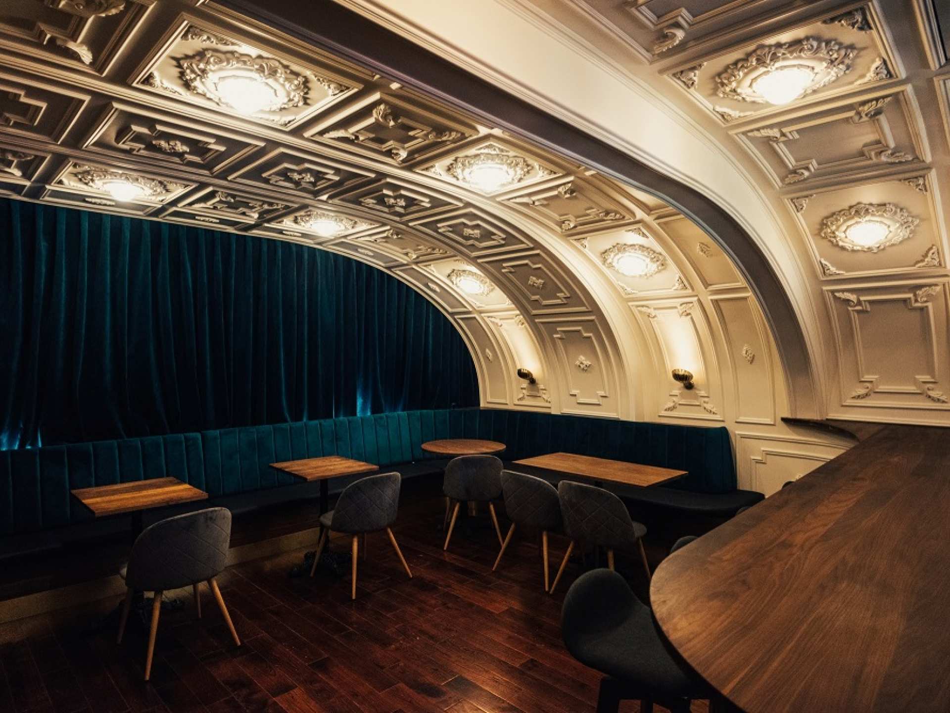 The table and lush blue curtain at Bar Avelo