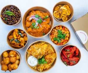 Cookin app for homemade food delivery | A spread of dishes in takeout containers from Tastes of Telanga