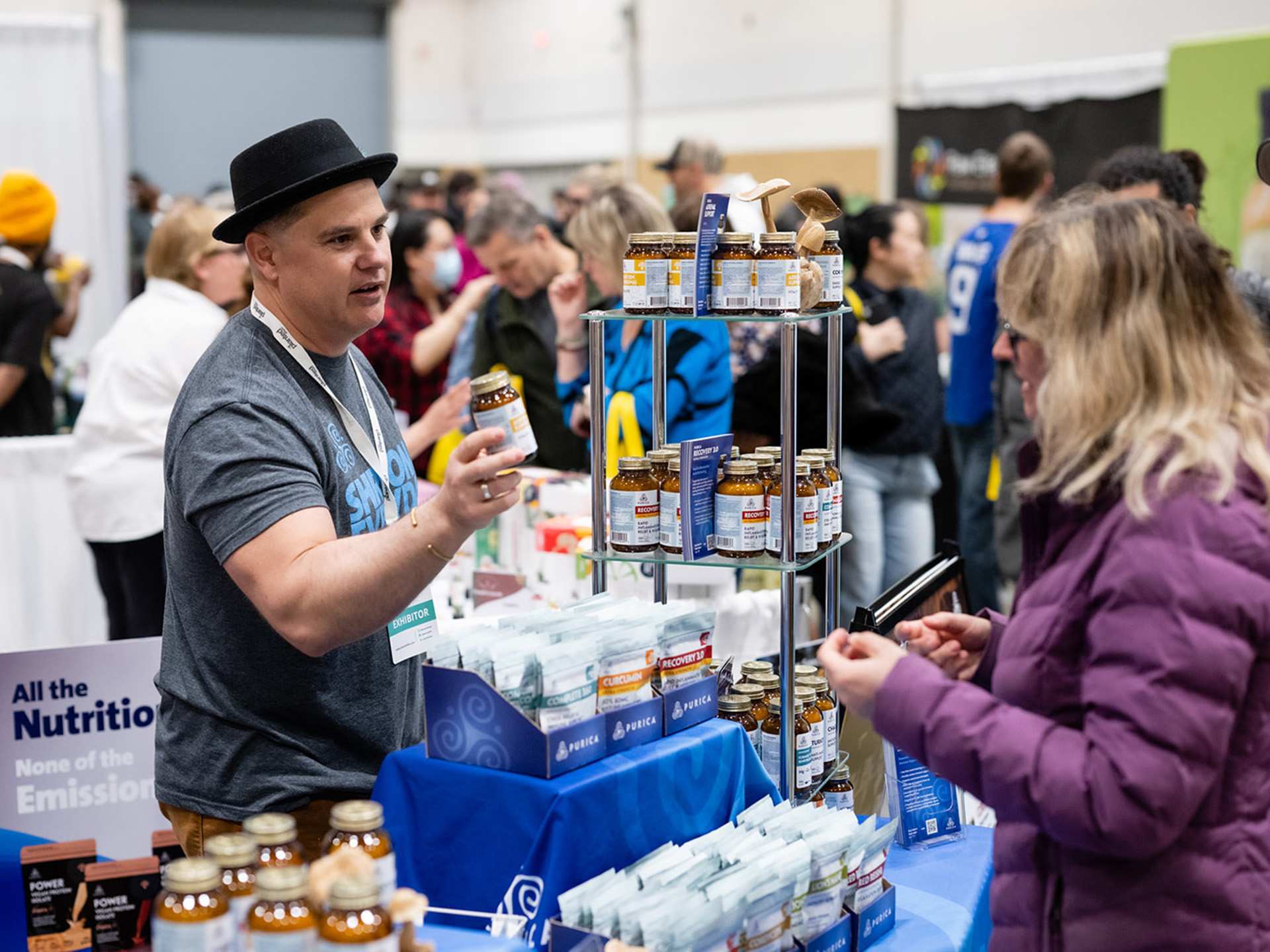 A vendor handing out a wellness products at Planted Expo Toronto