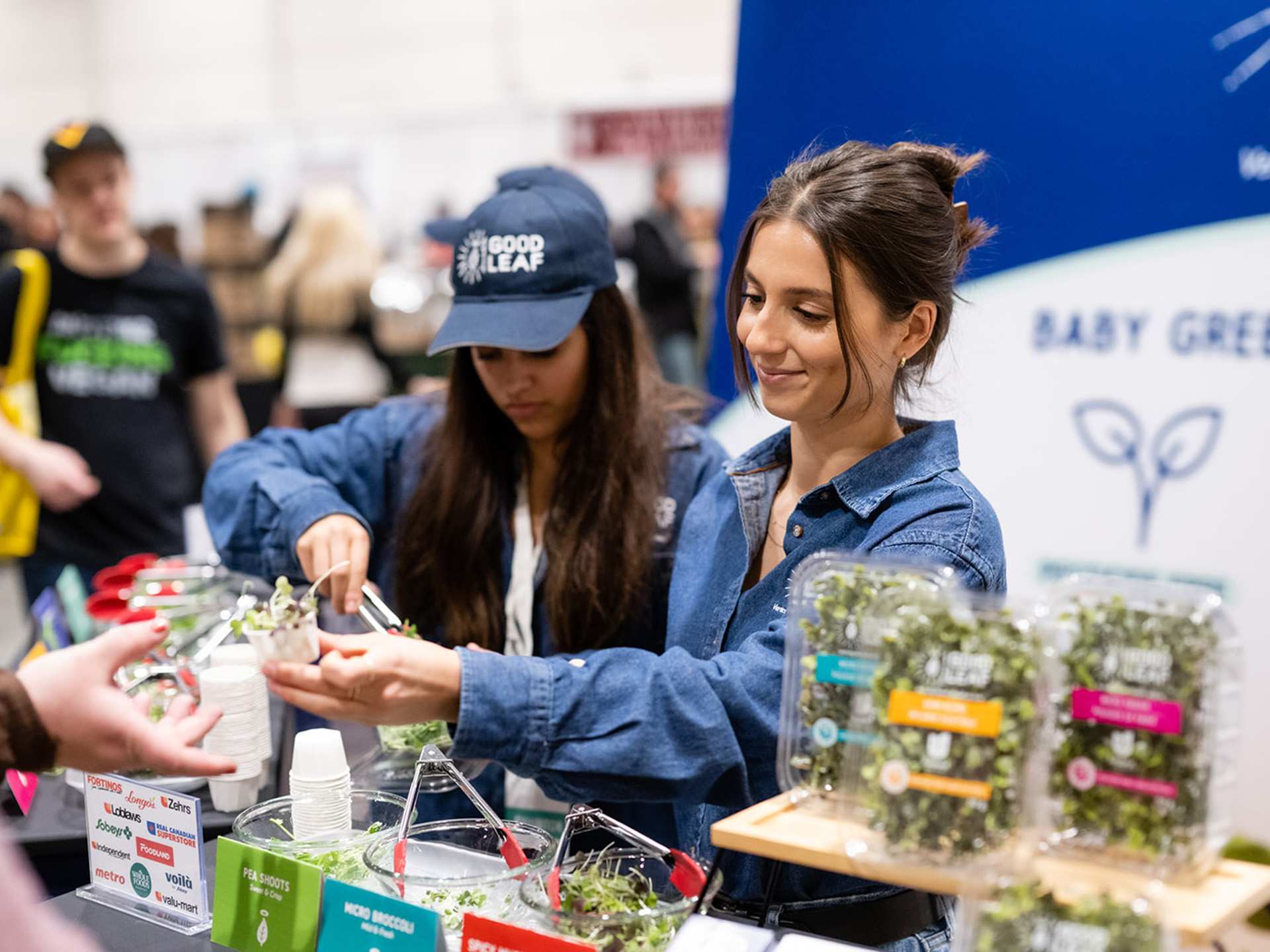 Two vendors handing out microgreens at Planted Expo Toronto